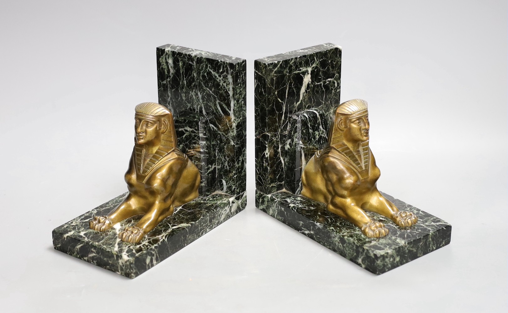 A pair of bronze and marble 'sphynx' bookends, 17cms wide x 15cms high